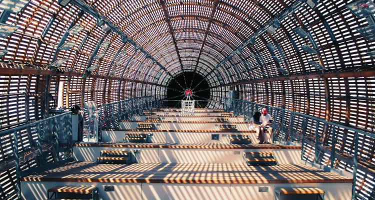 person sitting on brown box